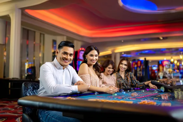 4777BE5 Casino — Step inside our high-end casino experience A glamorous woman holding casino chips in a neon-lit environment, representing the premium online casino atmosphere of 4777BE5.